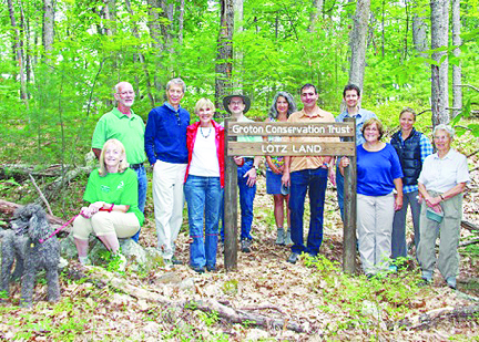 Bob and Sue Lotz, their children Joy and Bryson are joined by trustees Wendy Good, Bob Pine, Ed McNierney, Susan Hughes, David Pitkin, Holly Estes and honorary trustee Marion Stoddard at the land dedication August 9.